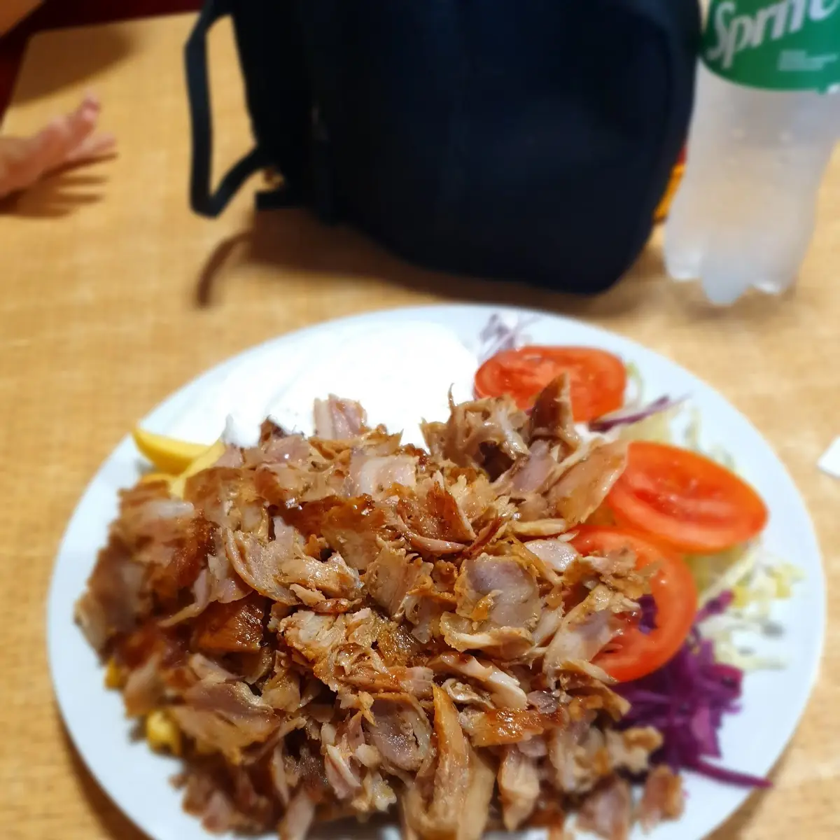 Doner Kebab on a Plate with French Fries Salad and Sauce