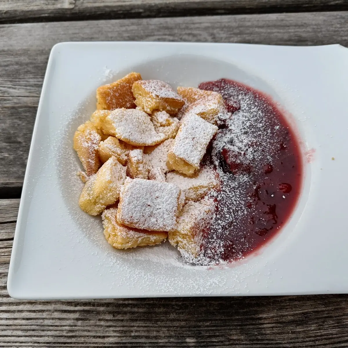 Cut-Up and Sugared Pancake with Stewed Plums