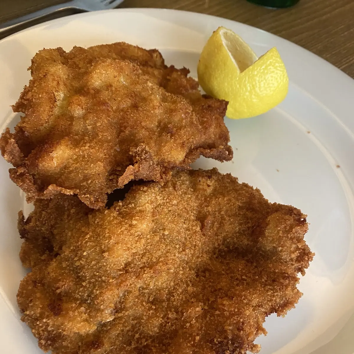 Original Wiener Schnitzel Of Veal Served With Potato-lettuce Salad And Lemon