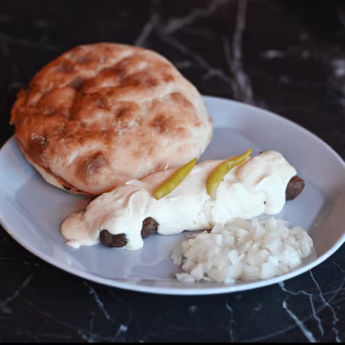 Cevapcici in Rahmsauce (7 Stück)